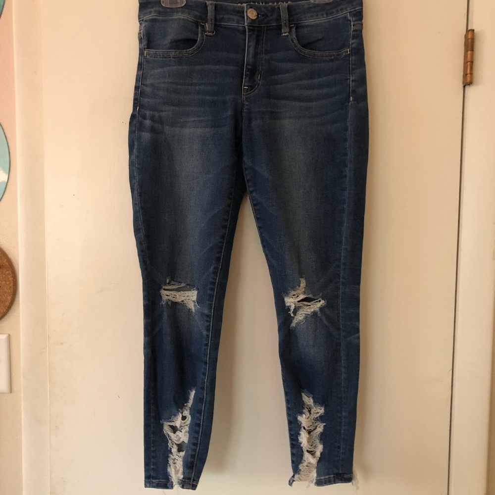 Blue skinny jeans with rips at knees and bottom